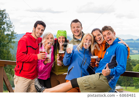 Posing smiling young people with beer outdoors Posing smiling young people with beer outdoors 6868481