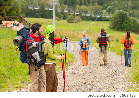 Hiking friends pointing and walking on path Hiking friends pointing and walking on path 6868483