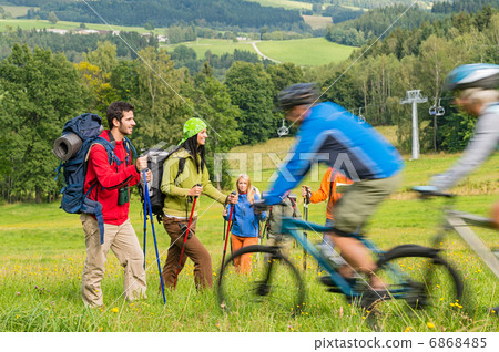 Tourists hiking and riding mountain bikes summer nature Tourists hiking and riding mountain bikes summer nature 6868485