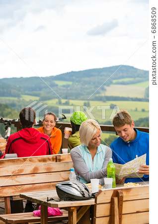 Young couple read map mountain bikers sport Young couple read map mountain bikers sport 6868509