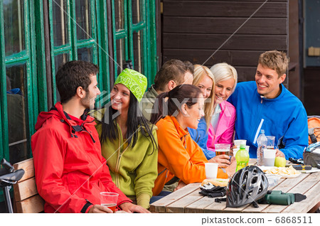 Smiling young friends talking with beer outdoors Smiling young friends talking with beer outdoors 6868511