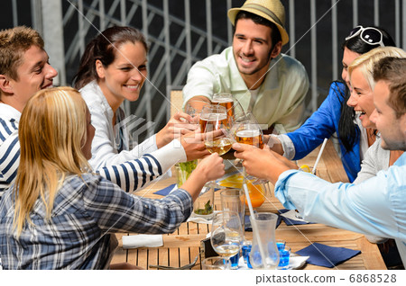 Group of cheerful people toasting with drinks 6868528