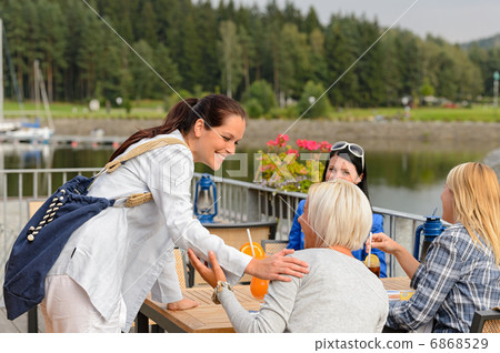 Woman arriving outdoor restaurant terrace friends 6868529