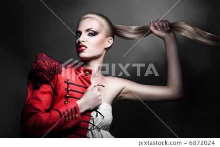 sexy blonde woman in red jacket with red lips and long tail 6872024