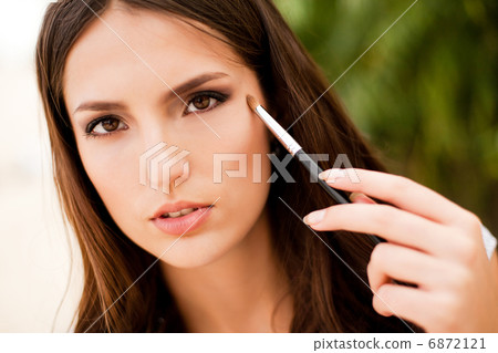 portrait of beautiful brunette girl making up 6872121