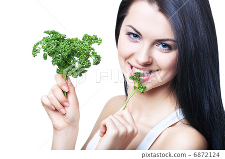 smiling girl biting parsley smiling girl biting parsley 6872124