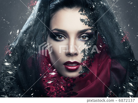 mysterious woman in black hood with gemstones 6872137