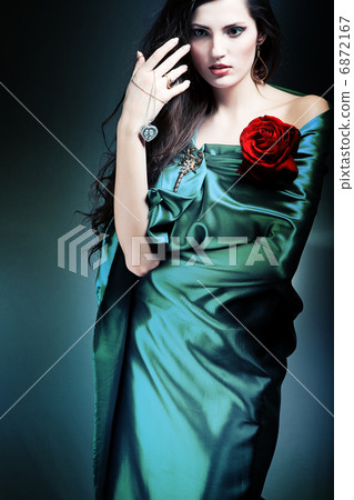beautiful woman in green fabric with red rose 6872167