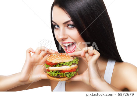 beautiful brunette woman biting hamburger 6872679