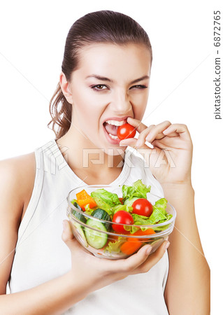 agressive woman biting tomato 6872765