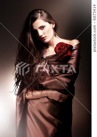 beautiful woman in chocolate fabric with red rose beautiful woman in chocolate fabric with red rose 6873414