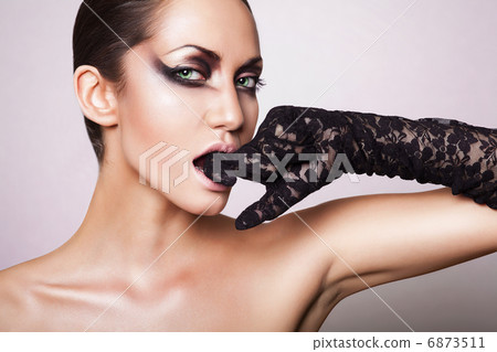 close up portrait of brunette woman with black glove in mouth close up portrait of brunette woman with black glove in mouth 6873511