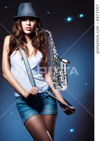 sexy attractive woman in shorts with saxophone 6873567