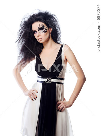 Brunette woman with face art and magnificent hair 6873574