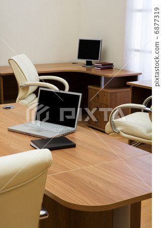 laptop on a table 6877319