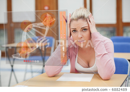 Woman looking worried over exam paper 6882489