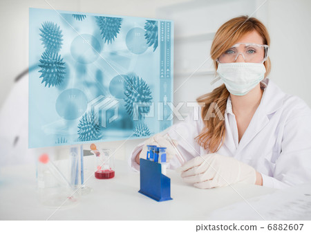 Female scientist conducting an experiment Female scientist conducting an experiment 6882607