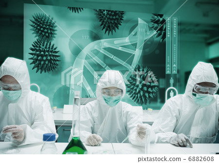Chemists in protective suits adding liquid to petri dishes 6882608