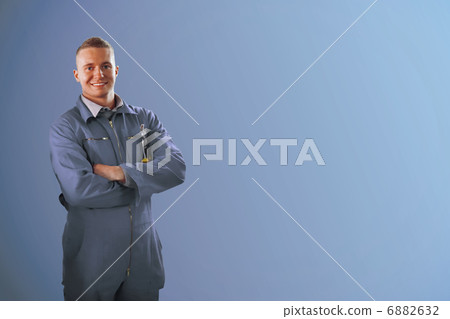 Smiling mechanics with arms crossed 6882632