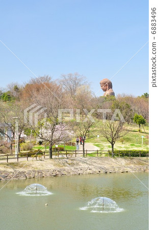 Park where Buddha statue is visible 6883496