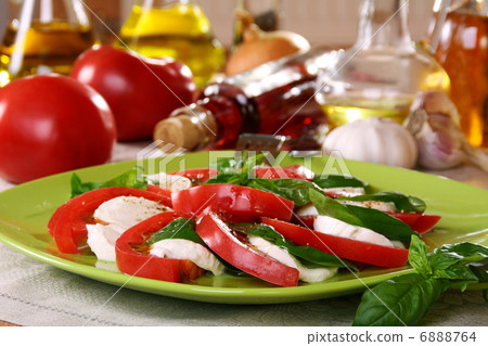 Salad caprese with fresh tomatoes, cheese and basil. Salad caprese with fresh tomatoes, cheese and basil. 6888764