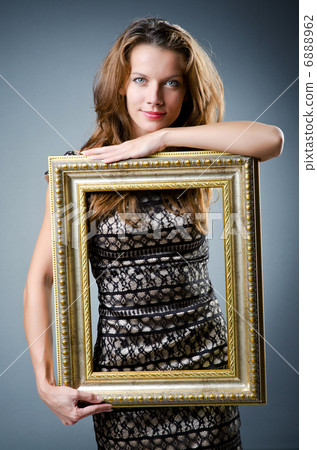 Young woman with picture frame on white 6888962
