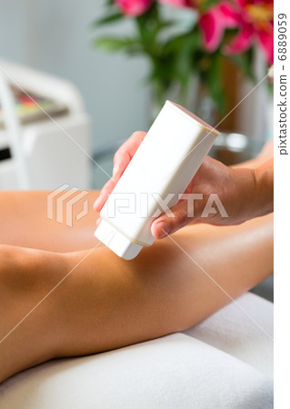 Woman in Spa getting leg waxed Woman in Spa getting leg waxed 6889059