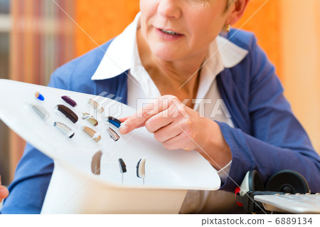 Deaf woman with hearing aid 6889134