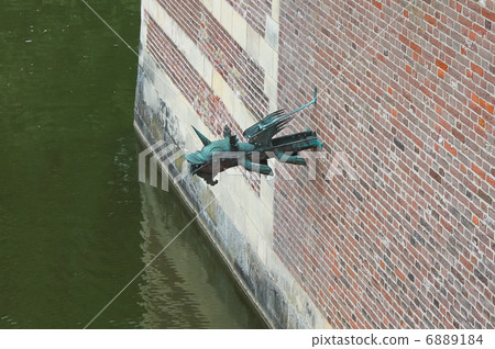 Gargoyle in the castle wall Heeswijk. Netherlands 6889184