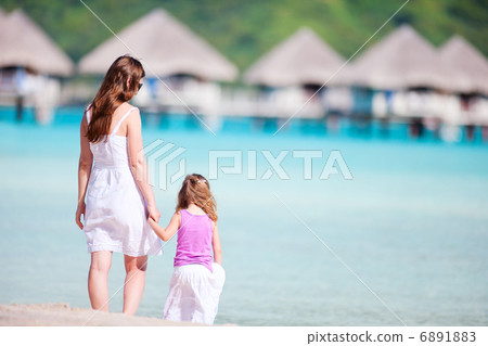 Mother and daughter at resort beach Mother and daughter at resort beach 6891883