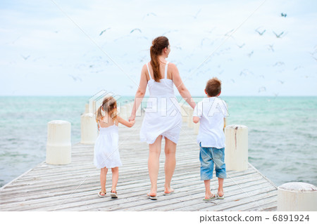 Mother and kids at seaside Mother and kids at seaside 6891924
