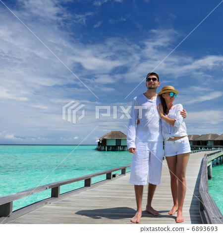 Couple on a beach jetty at Maldives 6893693