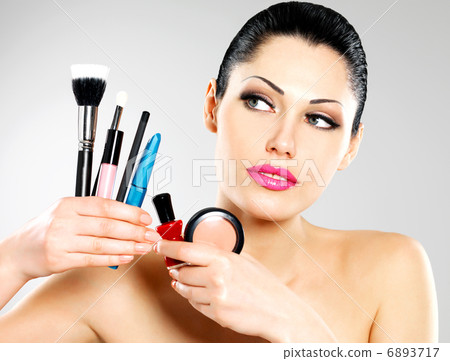 Beautiful woman with makeup brushes 6893717