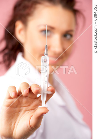 Female doctor hand holding syringe Female doctor hand holding syringe 6894353