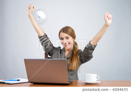 Businesswoman at desk with arms thrown up Businesswoman at desk with arms thrown up 6894635