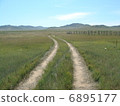 A rut following the grassland 6895177