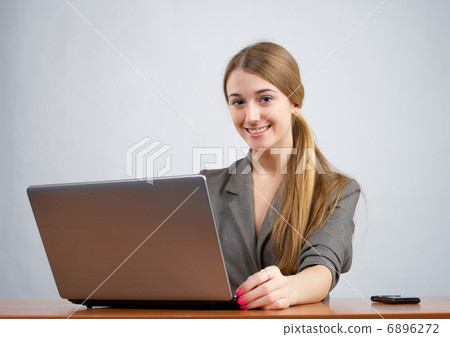 Young female executive working on laptop Young female executive working on laptop 6896272