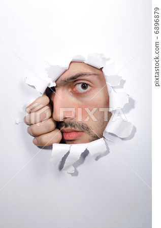 Male face through the hole in paper Male face through the hole in paper 6896879