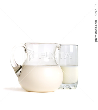 Pitcher and glass of milk on a white background. 6897115
