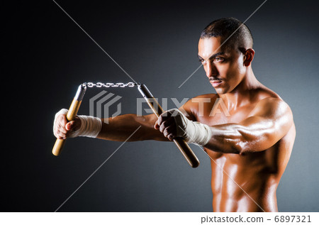 Strong man with nunchaku Strong man with nunchaku 6897321