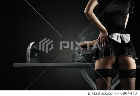 Vintage sexy maid with iron audio speakers on black background Vintage sexy maid with iron audio speakers on black background 6904470