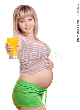 Portrait of pregnant woman with orange juice in hand isolated on 6904667