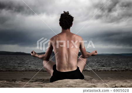 Man in the meditation on the shore of the sea Man in the meditation on the shore of the sea 6905028