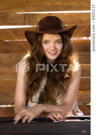 portrait of beautiful smiling cowgirl in stetson 6905217