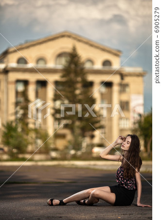young woman sitting at the street in city young woman sitting at the street in city 6905279