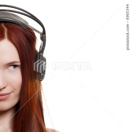 Beautiful young woman with headphones look on copyspace Beautiful young woman with headphones look on copyspace 6905344