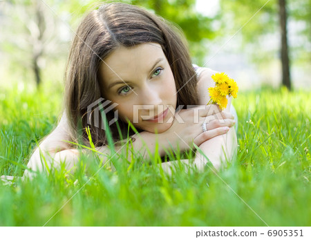 young beautiful teenager with dandelion on lawn young beautiful teenager with dandelion on lawn 6905351