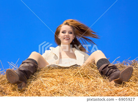 beautiful happy woman siting on haystack under blue heaven beautiful happy woman siting on haystack under blue heaven 6905927