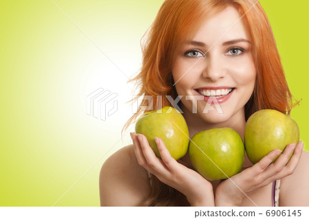 young beauty woman with apple on green background young beauty woman with apple on green background 6906145