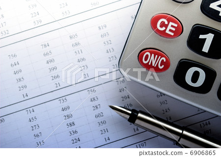 calculator and stationery items on the table 6906865